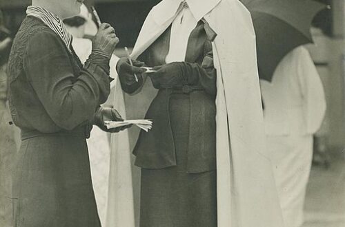 Ladies in dresses standing at the racetrack