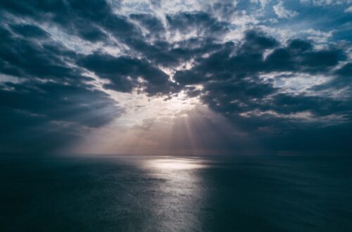 Sun rays in clouds over the ocean
